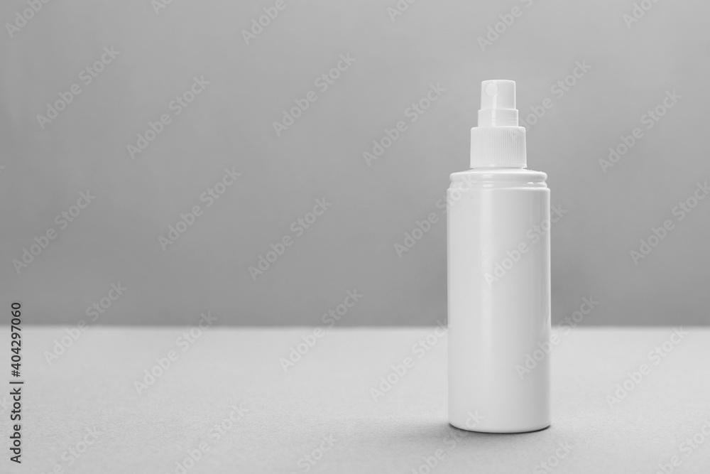 Bottle with insect repellent spray on grey background, space for text Bottle with insect repellent spray on grey background, space for text