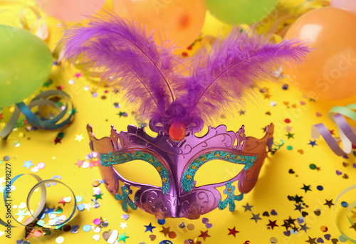 Beautiful purple carnival mask and party decor on yellow background © New Africa