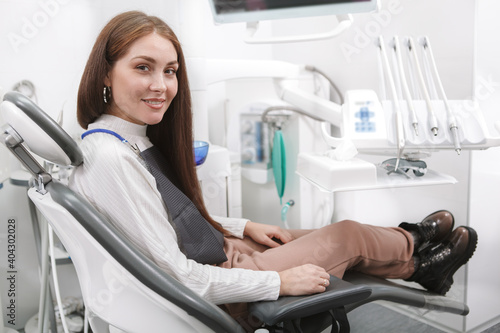 Happy woman with healthy white teeth smiling to the camera after dental checkup