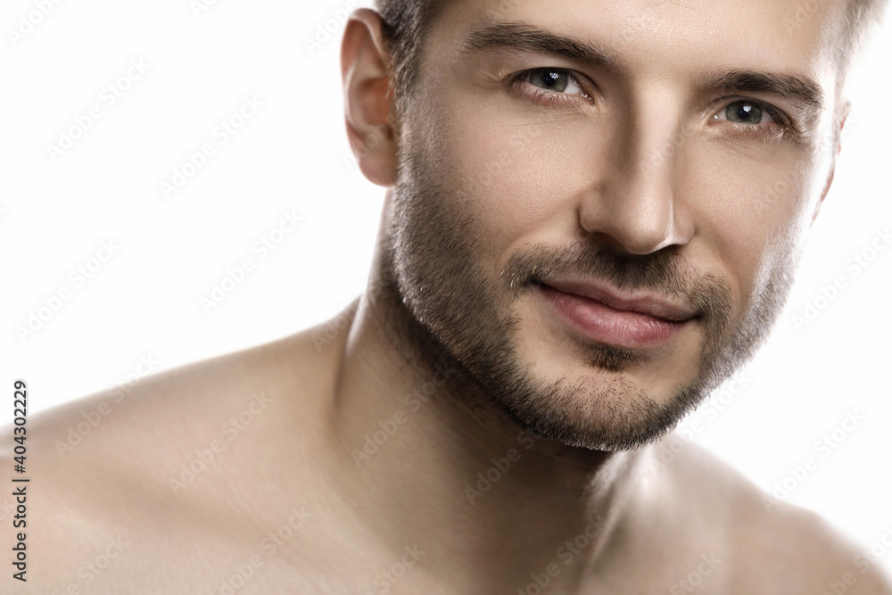 Young and handsome man with smooth skin on white background