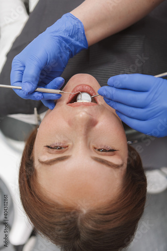 Vertical top view close up of woman getting dental examination