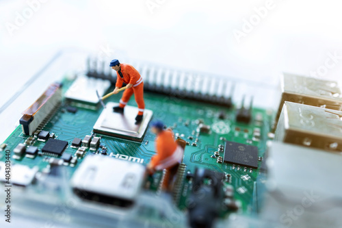 Canvas Print Miniature people searching or checking for bugs and issue on microchip, mainboard of computer