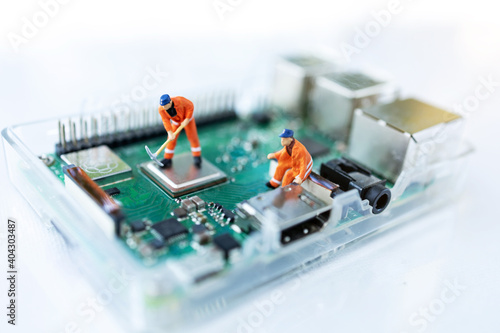 Miniature people searching or checking for bugs and issue on microchip, mainboard of computer. Vulnerability search and security system concept.
