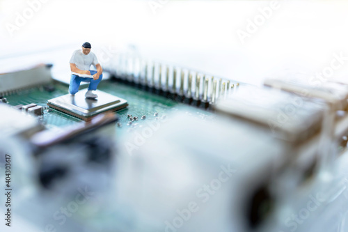 Miniature people searching or checking for bugs and issue on microchip, mainboard of computer. Vulnerability search and security system concept.