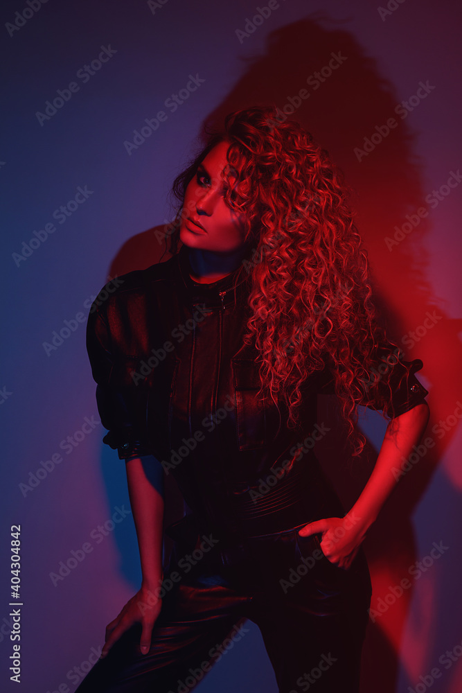 Young and sexy woman with a stylish Afro hairstyle wearing leather biker suit Young and sexy woman with a stylish Afro hairstyle wearing leather biker suit