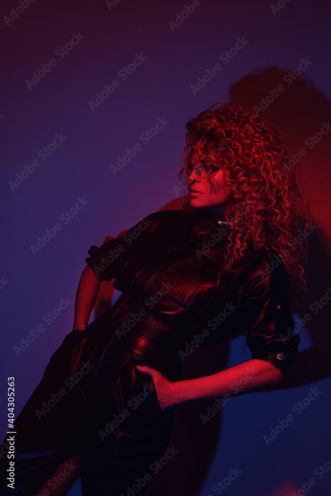 Young and sexy woman with a stylish Afro hairstyle wearing leather biker suit Young and sexy woman with a stylish Afro hairstyle wearing leather biker suit
