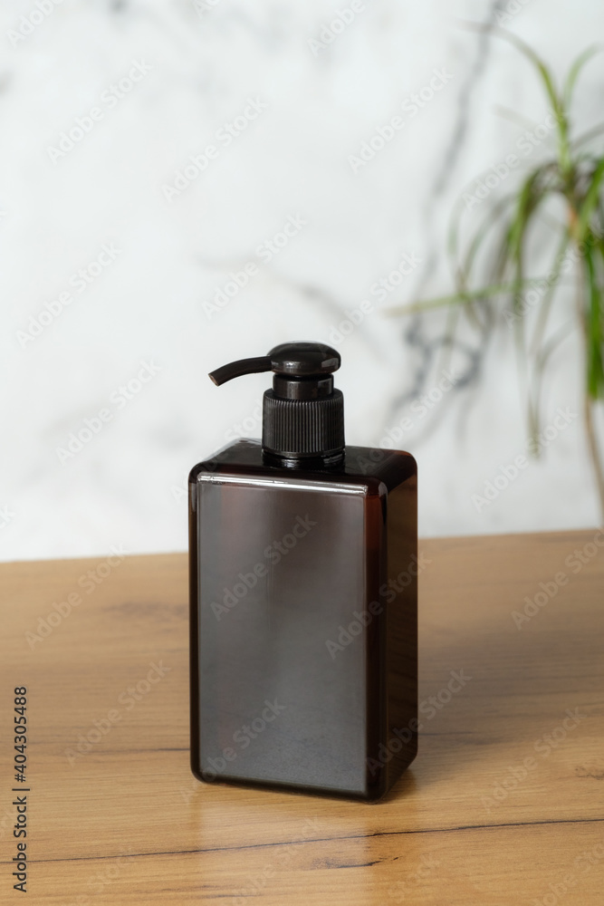 Brown amber glass pump bottle for natural organic cosmetics. Soap or shampoo dispenser, packaging design.