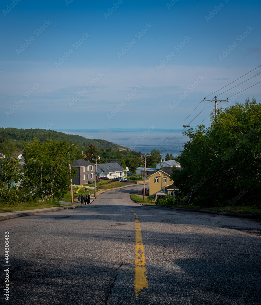 Road to the river in Tadoussac, Quebec, Canada, at summertime during the evening