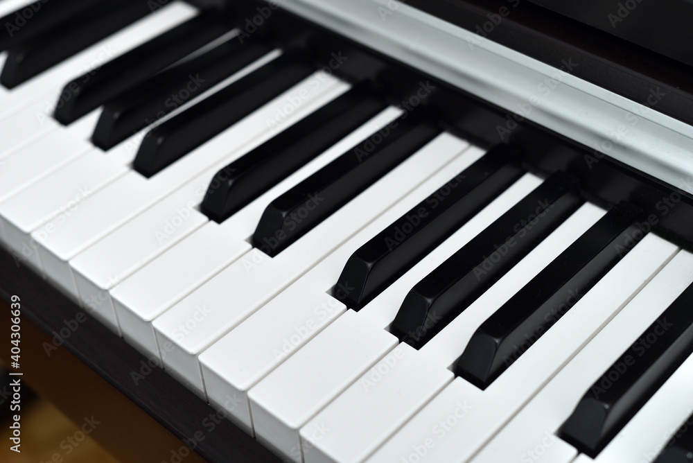 Piano keyboard with black and white keys. Closeup. Selective focus. 

