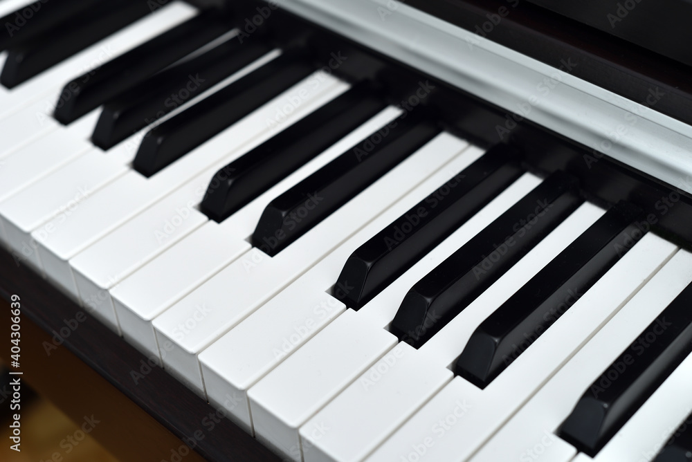 Piano keyboard with black and white keys. Closeup. Selective focus.
Piano keyboard with black and white keys. Closeup. Selective focus.