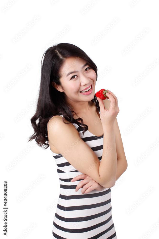 Young woman in a striped dress holding strawberry Young woman in a striped dress holding strawberry