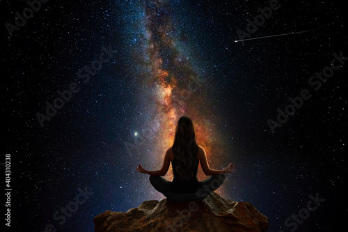 Woman with yoga pose in front of the universe