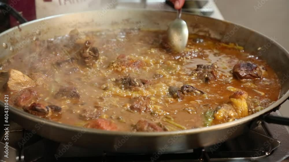 Authentic Valencian paella made with firewood. Making Valencian paella. How to make a paella. Meat paella with vegetables. Rice with meat and vegetables Authentic Valencian paella made with firewood. Making Valencian paella. How to make a paella. Meat paella with vegetables. Rice with meat and vegetables