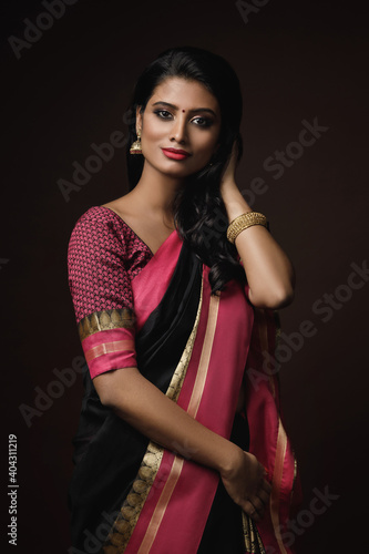 Fotografie Beautiful Indian woman wearing traditional sari dress