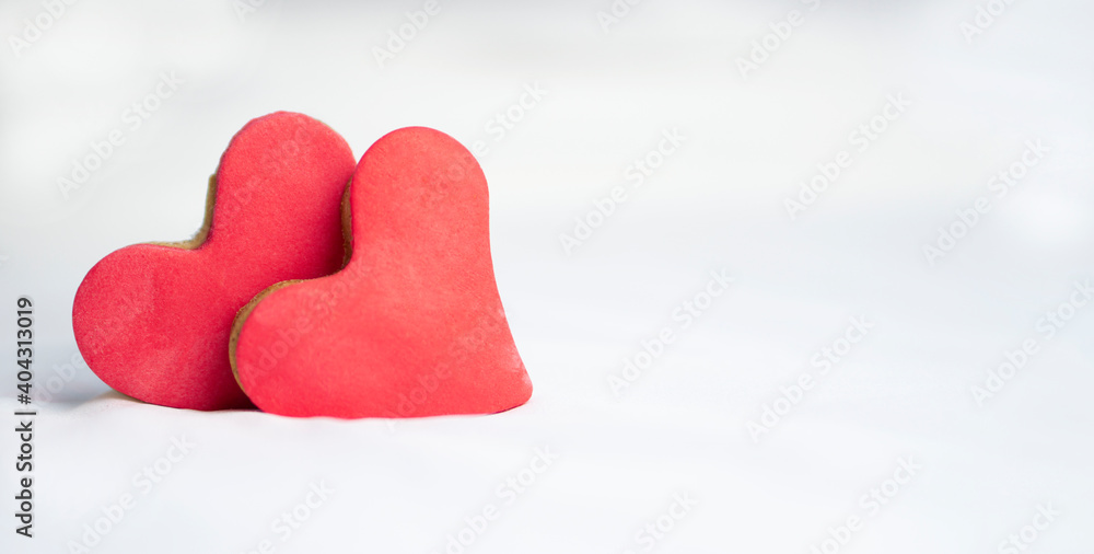 Fototapeta premium Two heart shaped cookies on white soft background .Valentines day greeting card . Chrictmas and winter romantic Winter Concept.
