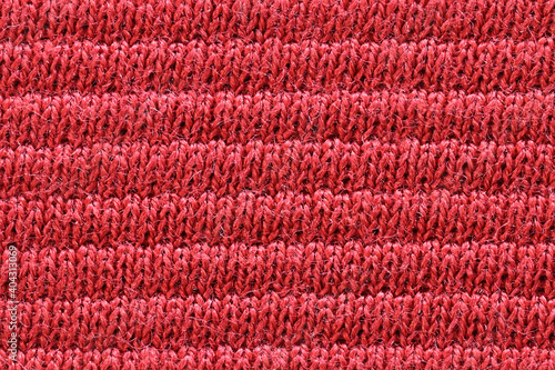 Texture of red cotton fabric, close-up.