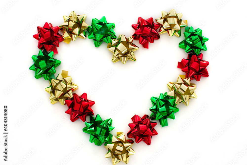 Heart made of colorful bows isolated on white background, flatly. Packing of presents for Valentine's day idea. Heart made of colorful bows isolated on white background, flatly. Packing of presents for Valentine's day idea.