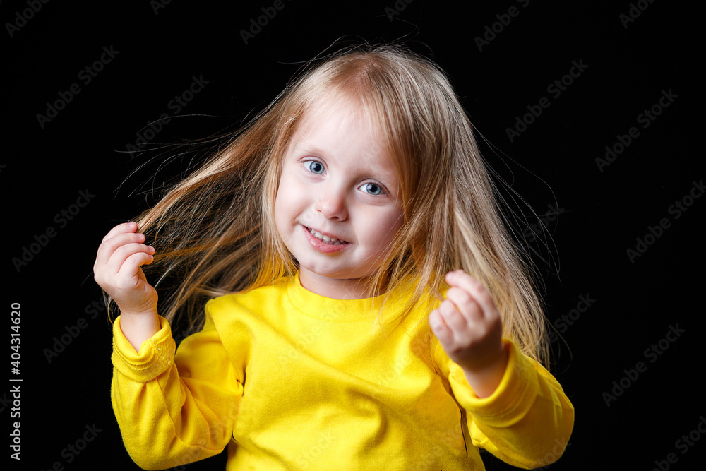 Portrait of a funny little girl on a dark background Portrait of a funny little girl on a dark background