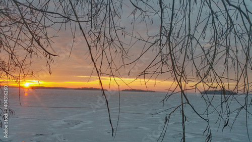 Sunrise in a cold winter morning with a icy lake in background