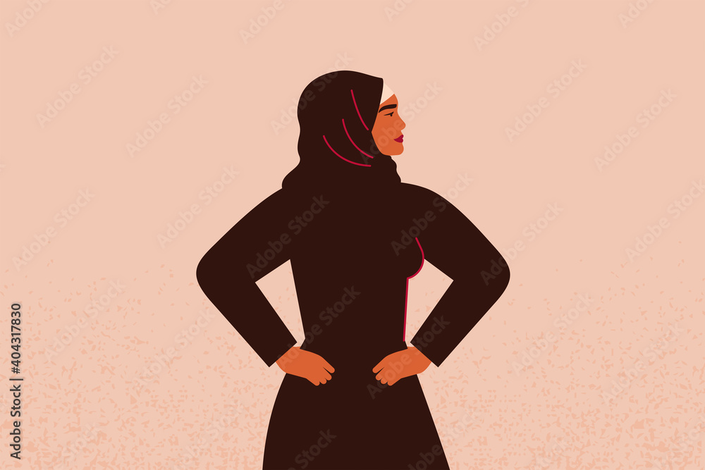 Young strong muslim female with hands on her hips looks forward. Confident Arabian Businesswoman or entrepreneur in abaya. Concept of gender equality and of the female empowerment movement. Young strong muslim female with hands on her hips looks forward. Confident Arabian Businesswoman or entrepreneur in abaya. Concept of gender equality and of the female empowerment movement.