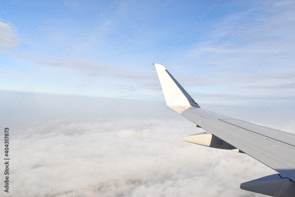 Fototapeta premium Beautiful white clouds floating high angle air, viewed from airplane window.
