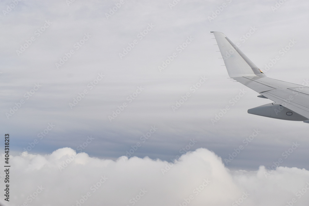 Fototapeta premium Beautiful white clouds floating high angle air, viewed from airplane window.