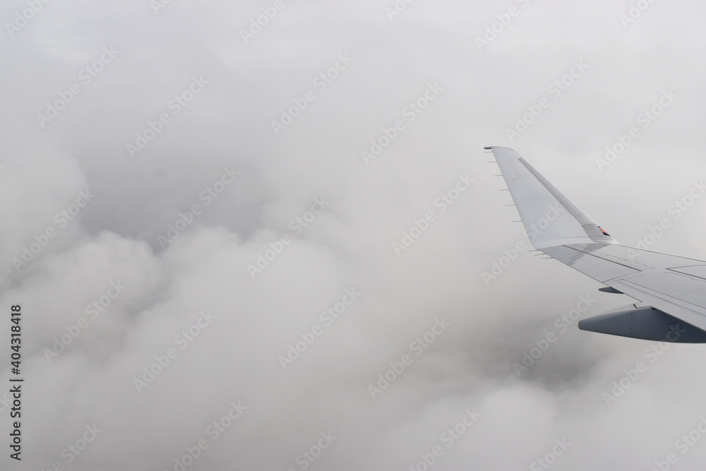 Fototapeta premium Beautiful white clouds floating high angle air, viewed from airplane window.