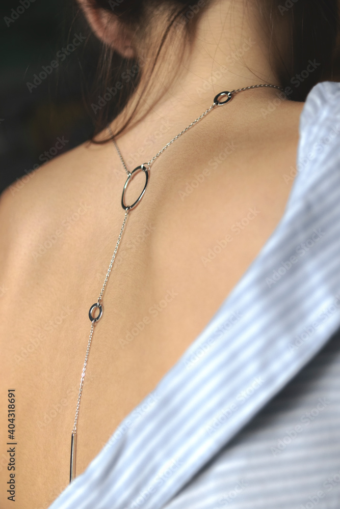 Jewelry. Necklace on the girl. Womens back with jewelry