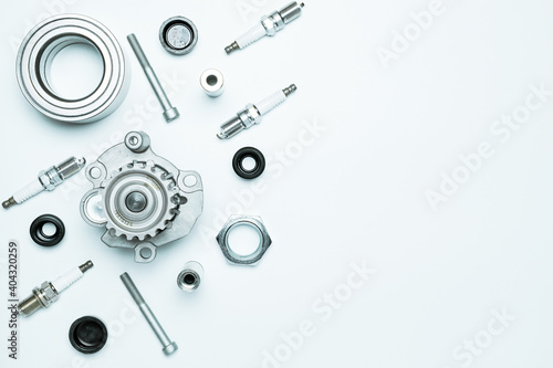 Auto valve. Motor mechanic spare or automotive piece isolated on white background. Set of new metal car part. Flat lay, top view, copy space.