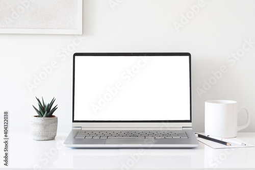 Workspace desk, laptop, coffee cup and pen. Business image, Blank screen laptop and supplies. laptop mock up screen view. work from home concept