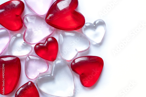 Valentine's day background with hearts. Shiny glass hearts on white background.