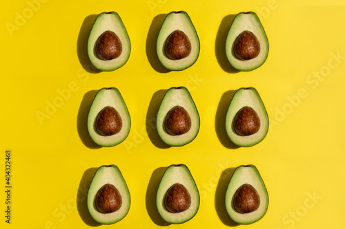 Multiple avocados on yellow background