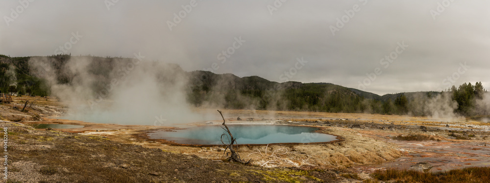 Panorama shot of blue thermal lagoon with brown border in yellowstone national park in america Panorama shot of blue thermal lagoon with brown border in yellowstone national park in america