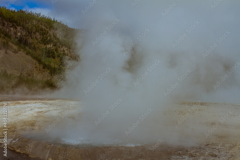 close up of hot blasting water from active gushing gayser in yellowstone national park in america