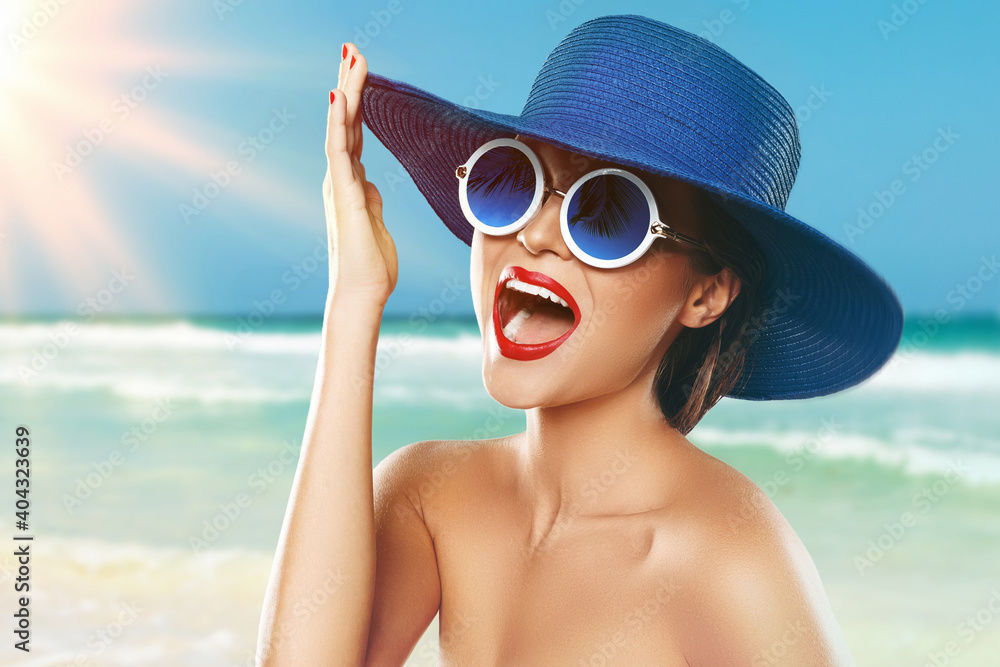 Beautiful woman wearing blue hat and sunglasses enjoying beach vacation - obrazy, fototapety, plakaty 