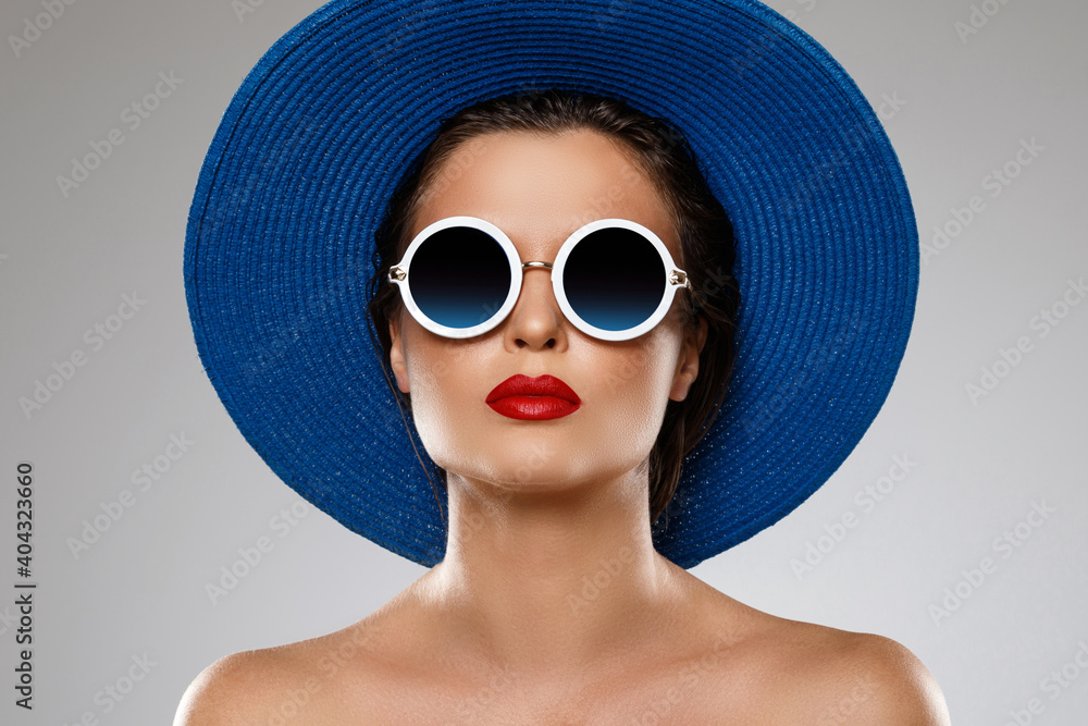 Beautiful woman wearing blue hat and sunglasses is ready for vacation Beautiful woman wearing blue hat and sunglasses is ready for vacation