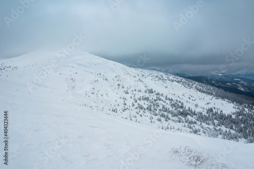 amazing winter landscape. mountains covered with snow and blue cloudy sky © ver0nicka