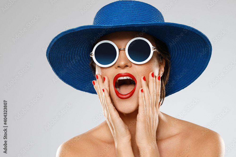 Beautiful woman wearing blue hat and sunglasses is ready for vacation Beautiful woman wearing blue hat and sunglasses is ready for vacation