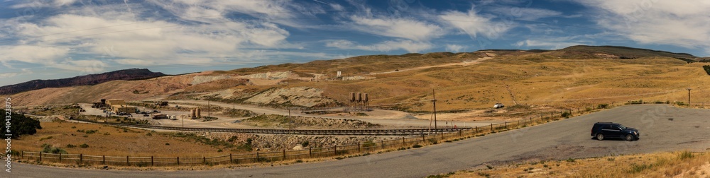 Panorama shot of car parking by iron ore mine in american nature