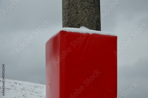 foam barrier on a pole near the ski slope. The protective mattress covers the poles at the lift and the electric pole. impact zone protects skiers and children, athlete from fatal devastating injury photo