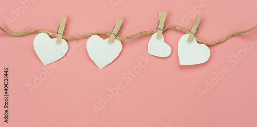 Table top view aerial image of valentine 's day background concept.Love text hang on rope clotheslines.Flat lay on modern rustic pink paper.pastel tone.Items create by handmade sign for the season.