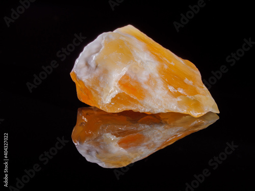 Photos Calcite orange close-up. Black background. Macro image.