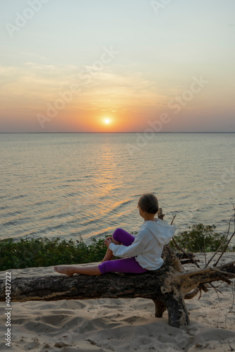 Girl relaxing on sunset over sea