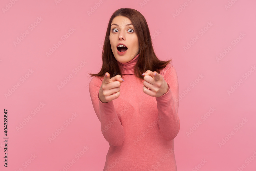 You are special! Surprised wondered woman with brown hair pointing fingers looking at camera with open mouth and big eyes, shocked with choice. Indoor studio shot isolated on pink background You are special! Surprised wondered woman with brown hair pointing fingers looking at camera with open mouth and big eyes, shocked with choice. Indoor studio shot isolated on pink background