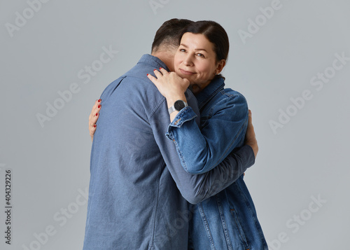 Studio shot of beautiful senior couple posing against a grey background  in casual clothes isolated over grey background © igor_kravtsov