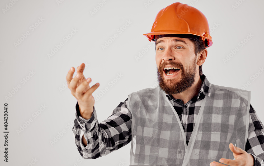 emotional builder in an orange hard hat and reflective pity on a light background emotional builder in an orange hard hat and reflective pity on a light background