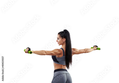 View from the back to a fitness woman with a dumbbell isolated on white background.
