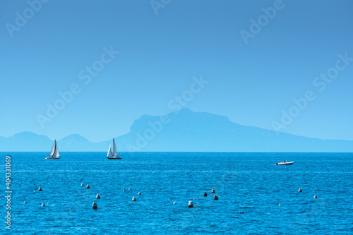Mediterranean landscape. Sea view of the Gulf of Naples and the silhouette of the island of Capri in the distance at the sunny afternoon. The province of Campania. Italy.