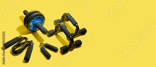 Obraz na płótnie flat lay of sport and fitness equipment on yellow background with copy space. illuminating banner of stay home training and workout concept. w salonie