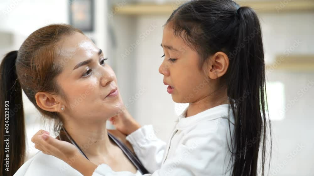 Loving Asian mother touching upset little daughter face , crying , mom comforting offended showing love and care, child psychologist concept, close up. Loving Asian mother touching upset little daughter face , crying , mom comforting offended showing love and care, child psychologist concept, close up.